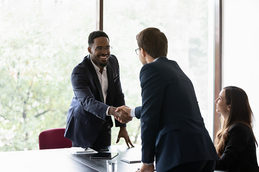 illustration, Business Shake Hands, Two Men Agreeing on a Deal Two men stand across from each other