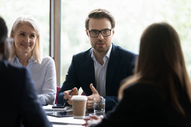 istock Leader and colleagues discussing new project during group meeting 1257268349