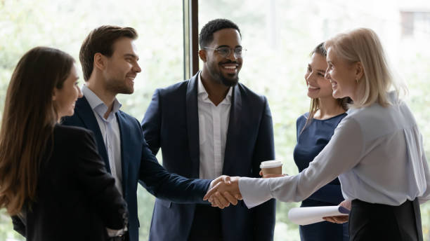 istock Middle aged businesslady handshake greeting business partner express respect 1257268395
