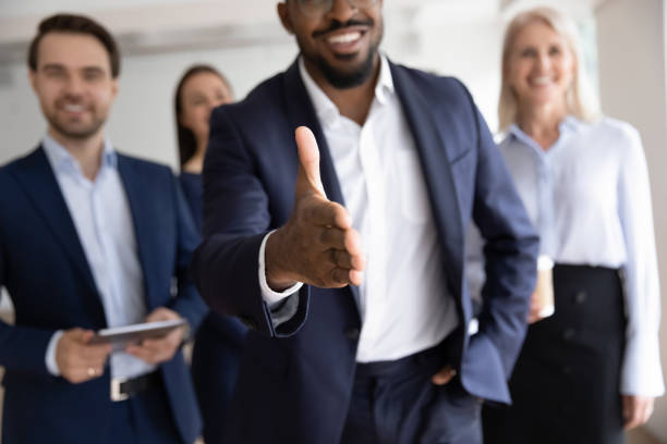 istock African boss holds out his hand for handshake welcoming customer 1257268414