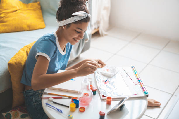 istock Girl practicing art with paint and brushes 1257268536