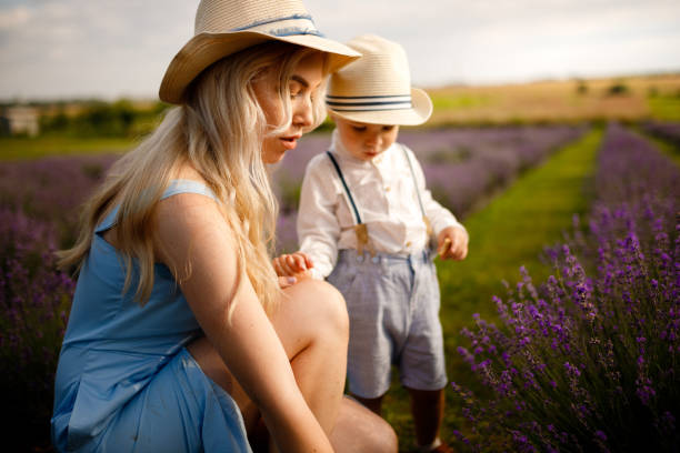 istock Little boy walking with his mother on a lavender field. 1257268610
