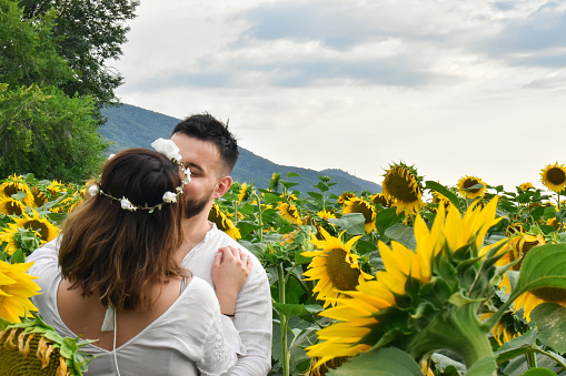Husband and wife in sunflower field
