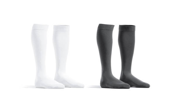 Blank black and white soccer socks mockup pair, half-turned view Blank black and white soccer socks mockup pair, half-turned view, 3d rendering. Empty elastic foot-wear uniform mock up, isolated. Clear fabric half-hose for football player mokcup template. football socks stock pictures, royalty-free photos & images