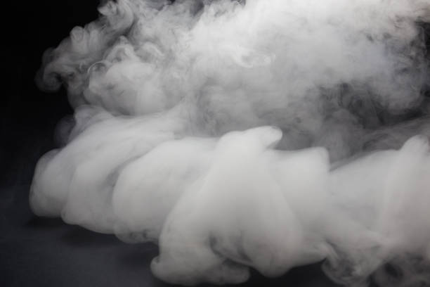 istock Cloud of white smoke on a black background closeup 1257270706