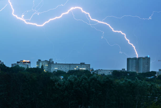 lightning strike at cloud city space. strike hit building apartments. urban landscape. - protection insurance dark rain imagens e fotografias de stock