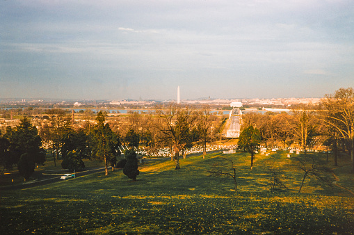 Washington DC in the 1950's from the Arlington National Cemetery. Arlington National Cemetery is a United States military cemetery in Arlington County, Virginia, across the Potomac River from Washington, D.C., in whose 624 acres the dead of the nation's conflicts have been buried, beginning with the Civil War, as well as reinterred dead from earlier wars. Copyright has expired on this artwork. Digitally restored. Historic photos shows the U.S. Capitol in 1950 and its surrounding areas of Washington D.C.