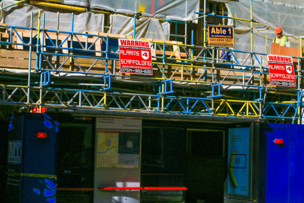 Alarms 4 Scaffolding in Westminster, London, with several other companies named and contact details such as phone numbers. A construction worker is visible on the right.