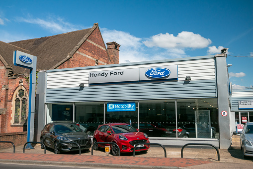 Henry Ford Dealership in Royal Tunbridge Wells, England, with cars and number plates visible in the foreground