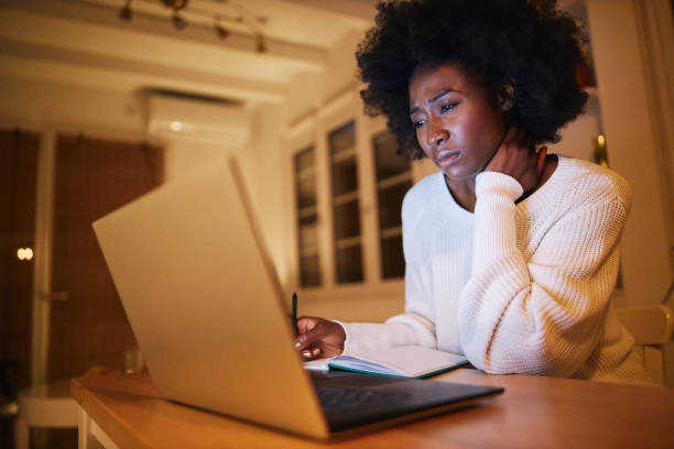 istock Young tired black woman working from home on a laptop computer 1257273270