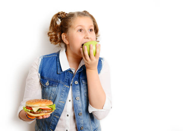 istock schoolgirl eating burger on white background 1257274754