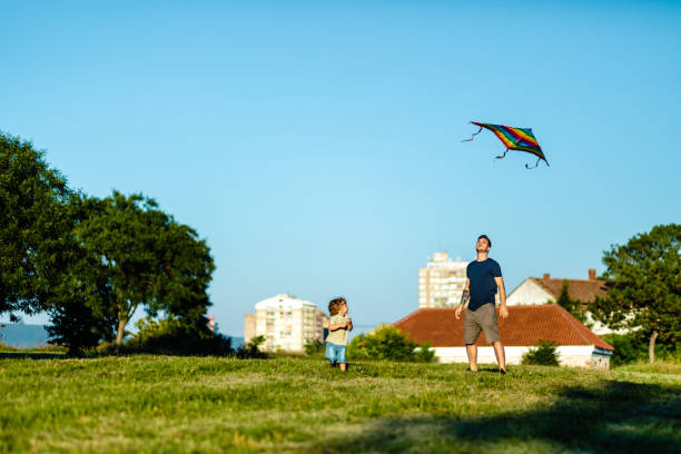 istock Single father spending amazing summer they with his son while play with colorful kite 1257276101
