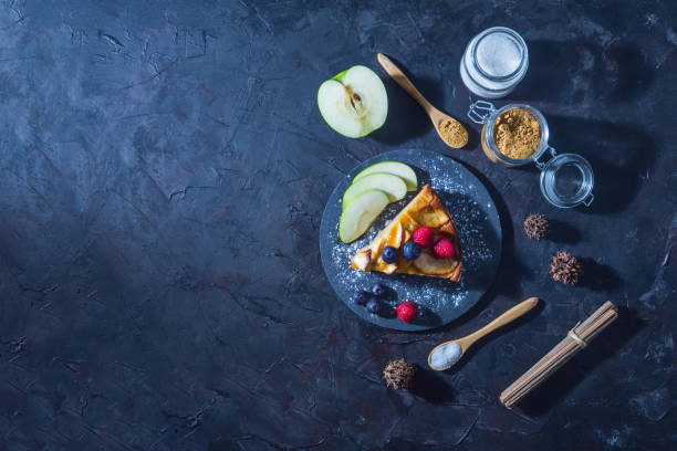 istock slice of apple pie on a slate plate with a dark rustic surface, top view and copy-space. Gastronomic concept 1257276972