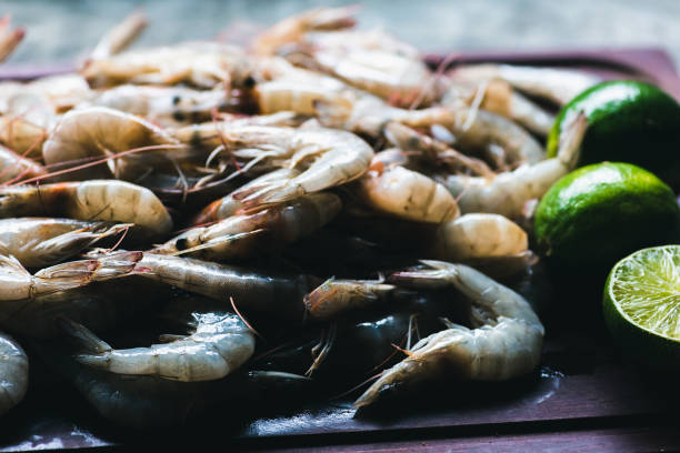 istock Raw shrimps on a wooden board 1257277228