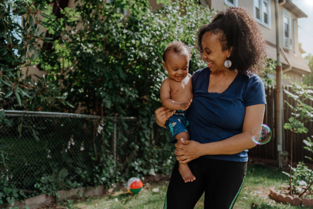 istock Black mother playing with bubbles with her baby son 1257277488
