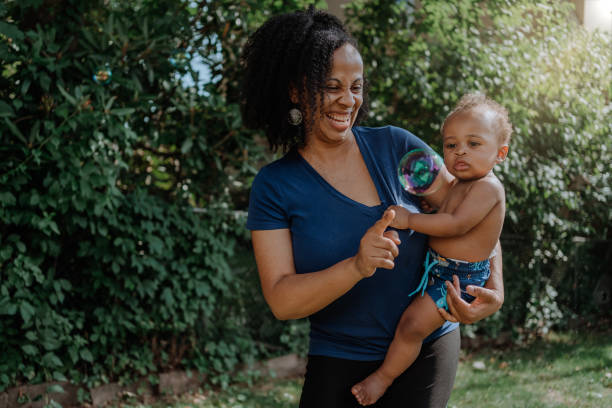 istock Black mother playing with bubbles with her baby son 1257277489