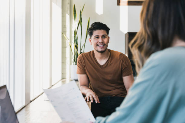 istock Unrecognizable woman discusses class notes with fellow student 1257278456