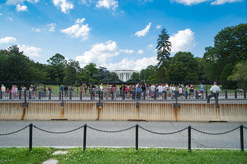 Washington DC, USA - July 6, 2016: Crowd of many people tourists at White House President building in capital city of United States