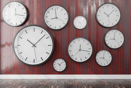 Group of wall clocks in a wooden wall .3d rendering