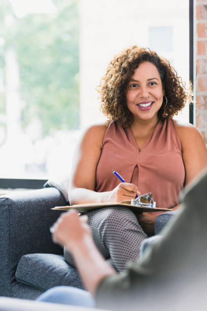 istock Therapist counsels female patient 1257279543
