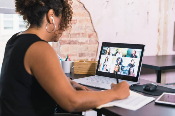 istock Businesswoman taking notes during video conference 1257279573