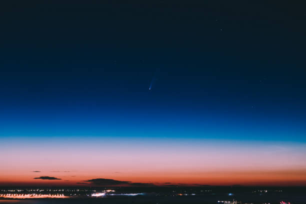 istock comet neowise in the sky over the night city 1257280481