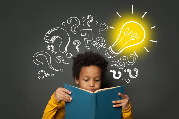 istock Intelligent black kid student reading book and having idea. Brainstorming and idea concept 1257280879