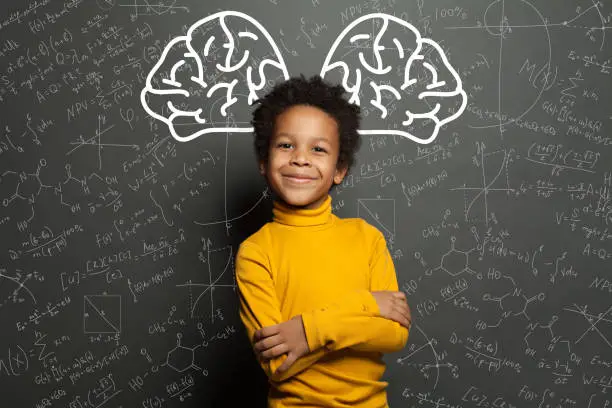 Photo of Smiling black child with big brain and science formulas on black, education and brainstorming concept