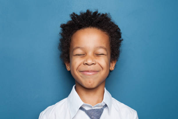 istock Happy black child boy maks a wish on blue background 1257280907