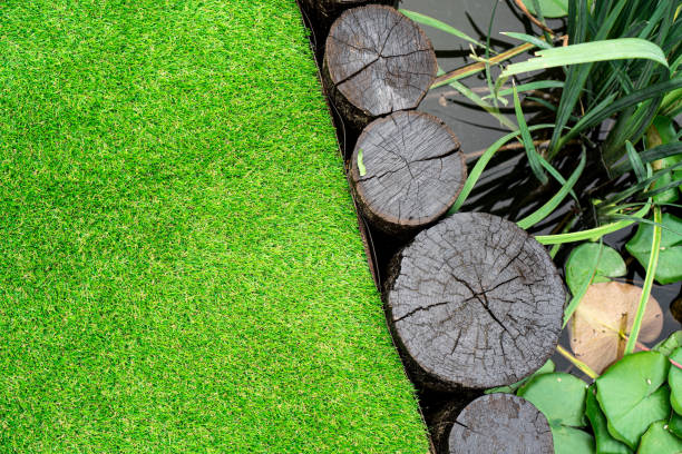 istock Artificial grass behind the little pond at the home yard 1257284267