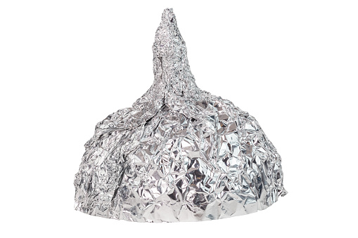 Sombrero de aluminio aislado sobre fondo blanco, símbolo para la teoría de la conspiración y protección de control mental. photo