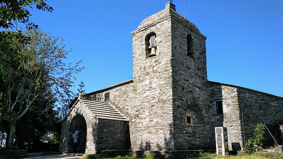 Pedrafita do Cebreiro ancient stone church and bell tower, mountanious area in Lugo province, Galicia, Spain, seen in \