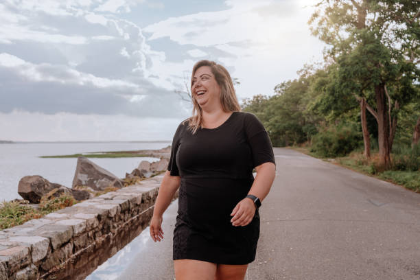 istock Woman walking outdoors with positive attitude 1257285570