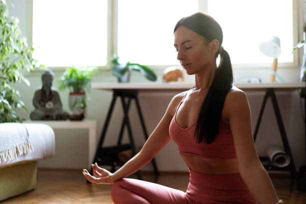 istock Woman meditating at home 1257285683
