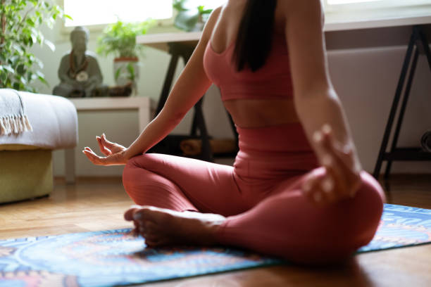 istock Unrecognizable woman meditating at home 1257285753
