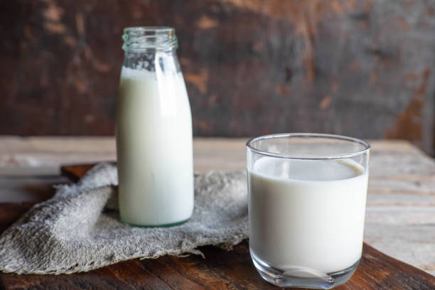 istock Bottles and milk glasses on a wooden table 1257291535