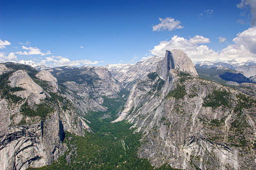 Springtime view of Half Dome from Glacier Point with snow covered peaks in background.

Taken in Yosemite National Park, California, USA