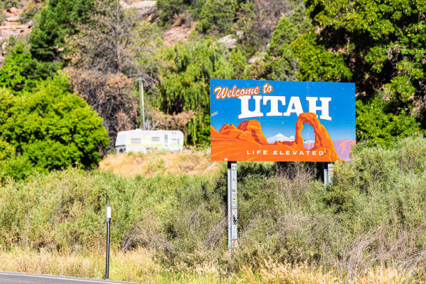 Sign closeup for welcome to Utah near Arches National Park and moab with famous arch La Sal, USA - August 14, 2019: Sign closeup for welcome to Utah near Arches National Park and moab with famous arch image on road highway from Colorado 46 90 la sal mountains stock pictures, royalty-free photos & images