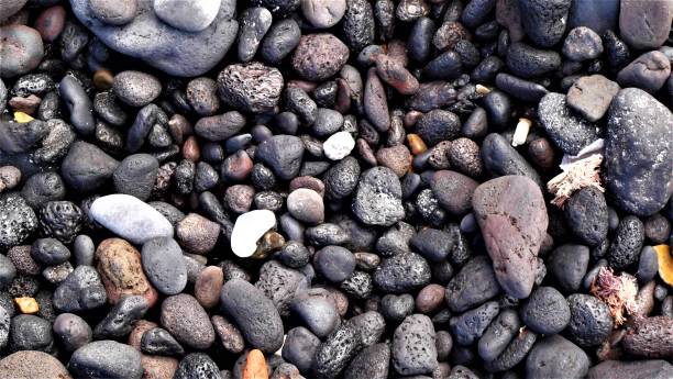 istock Dark colourful pebbles on the beach 1257294840