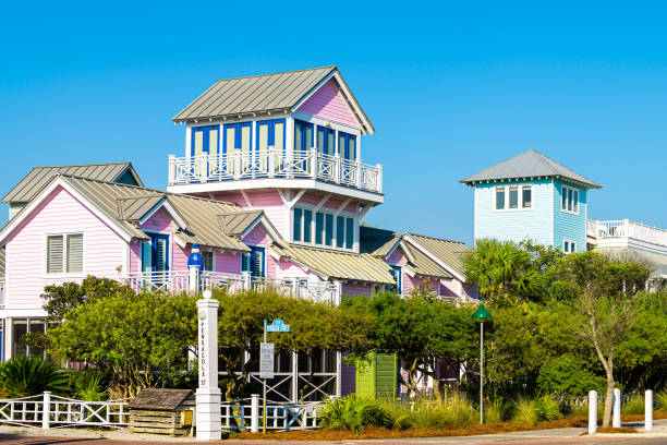 Pensacola street sign on road of city town village by beach during sunny day in Florida panhandle Seaside, USA - April 25, 2018: Pensacola street sign on road of city town village by beach during sunny day in Florida panhandle gulf of mexico coast with tow away zone new urbanism stock pictures, royalty-free photos & images