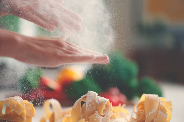 Chef finishing fresh pasta with flour ready for cooking.