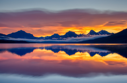 Vibrant sunrise in the beautiful natural scenery of Glacier National Park's Lake McDonald area in Montana, USA.