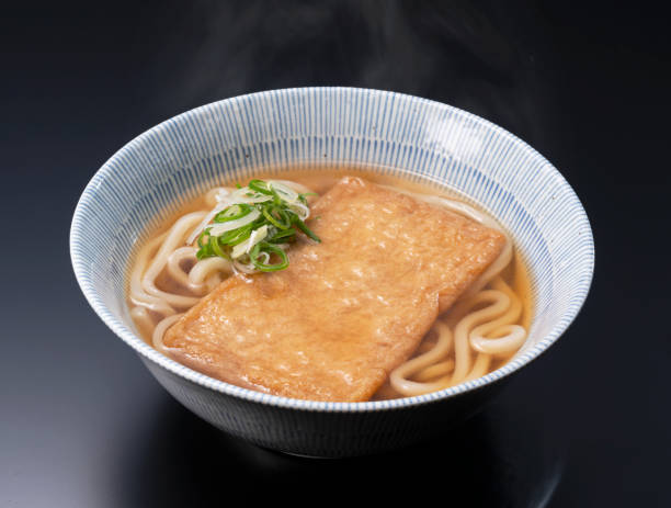 istock Udon noodles in a hot soup with deep fried tofu 1257298155