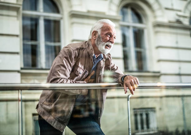 Senior man having chest pain while waiting on station.