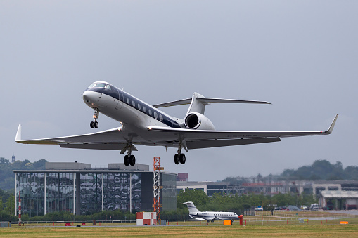 Farnborough, UK - July 19, 2014: NetJets Gulfstream Aerospace G550 luxury business jet aircraft CS-DKK taking off from Farnborough Airport.