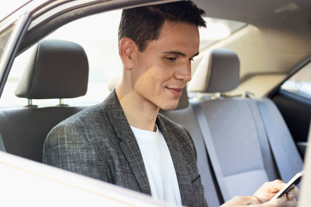 istock Handsome business man talking by phone inside a car. 1257308186