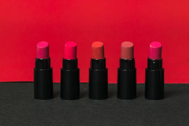 istock Five bottles of lipstick on a red and black background. 1257317556