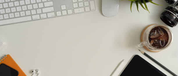 istock Scene creator with digital devices, supplies, stationery, camera and copy space on white table 1257319811