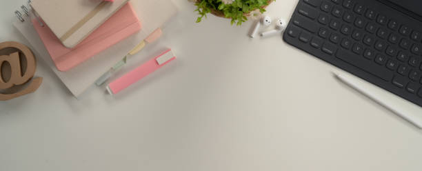 istock Study desk with copy space with digital tablet, stationery and decorations on white table 1257321530