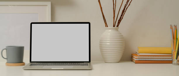 istock Modern study table with mock up laptop, stationery, books and decorations on white table 1257321556